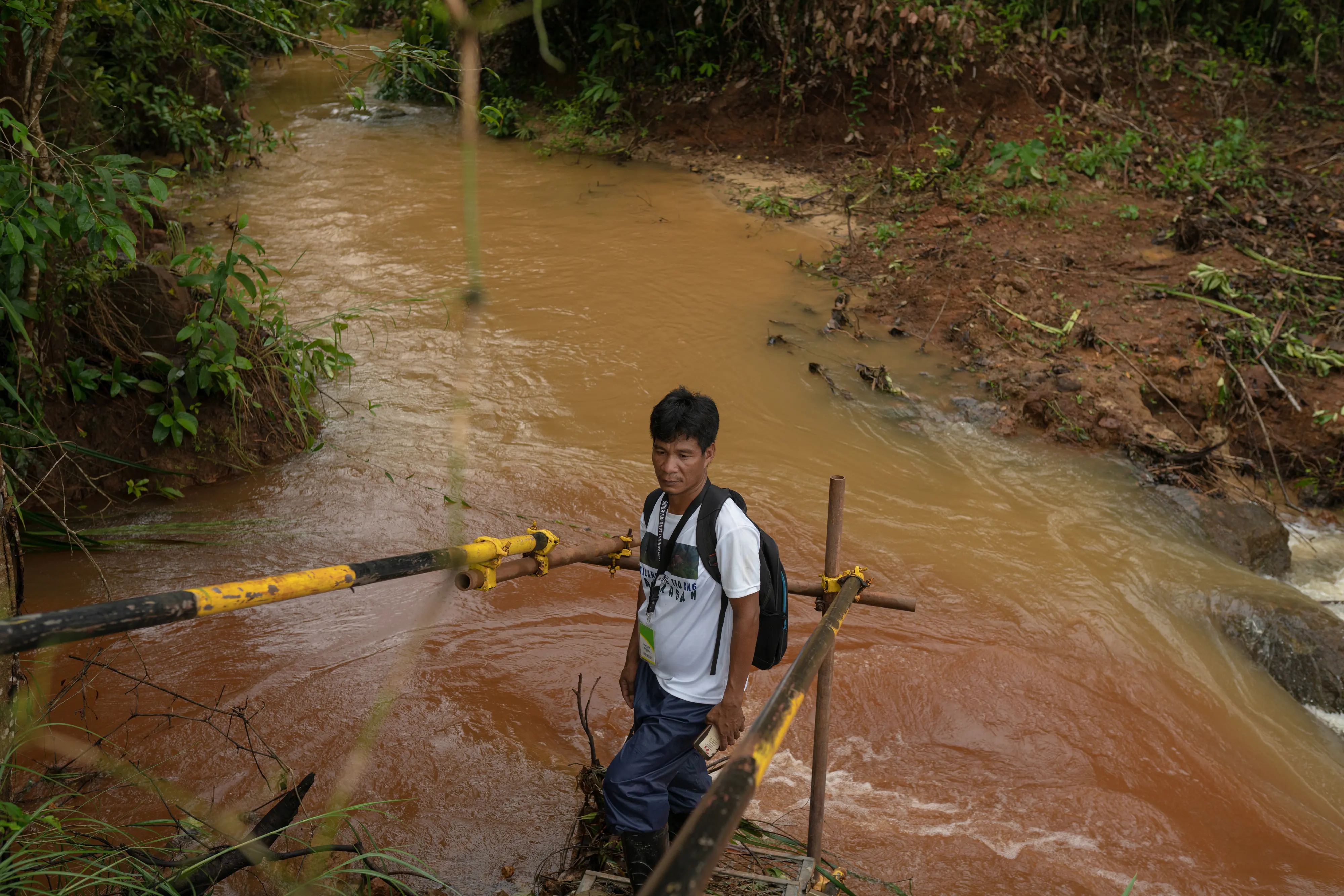 Tribe leader stands in pond discharge