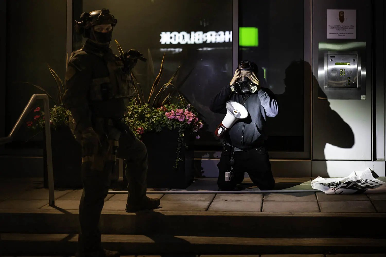 A Federal DHS officer corners a protester near the Federal Immigration and Customs Enforcement building in Portland, Oregon.