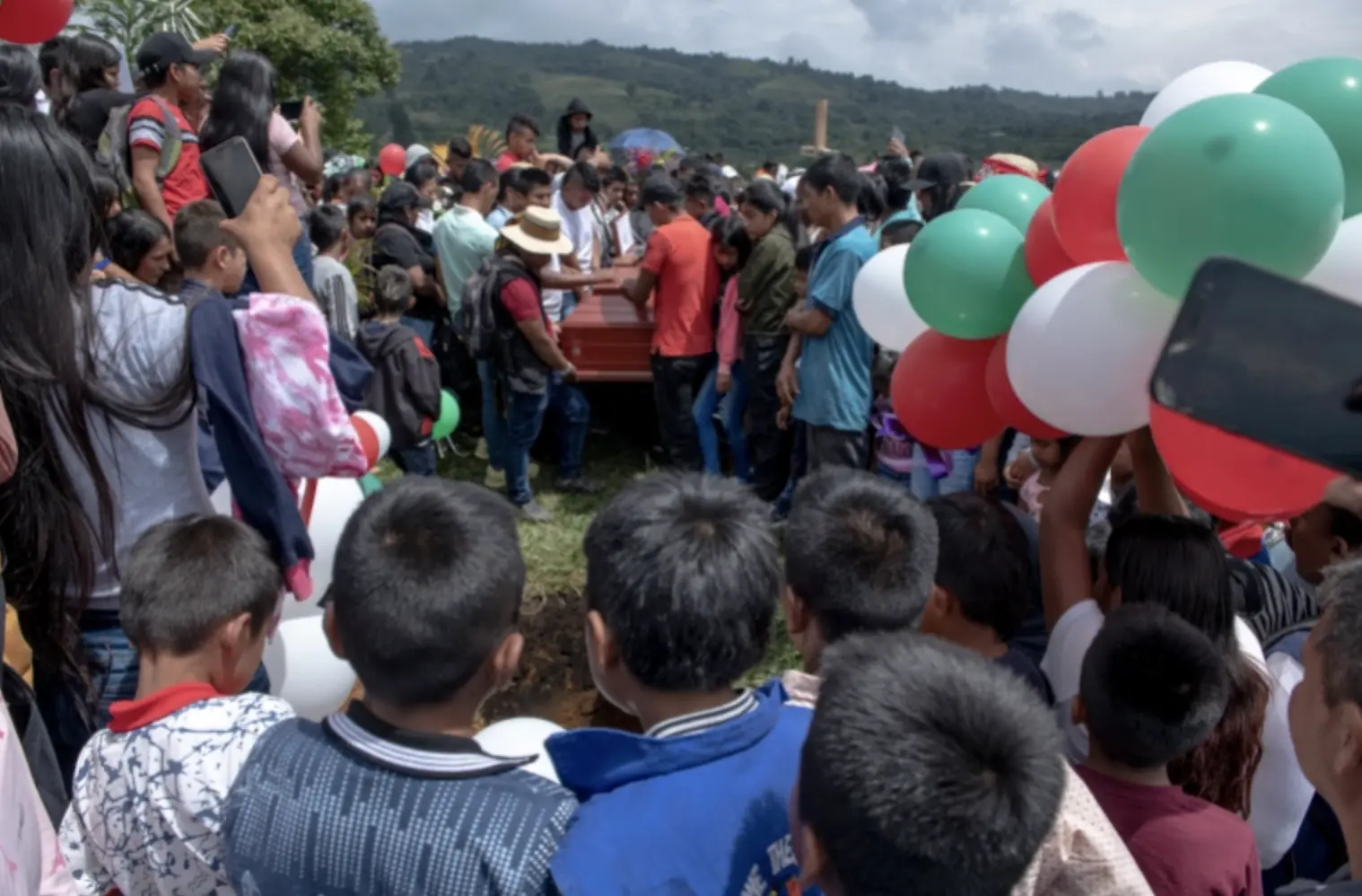 Young boys look over the burial