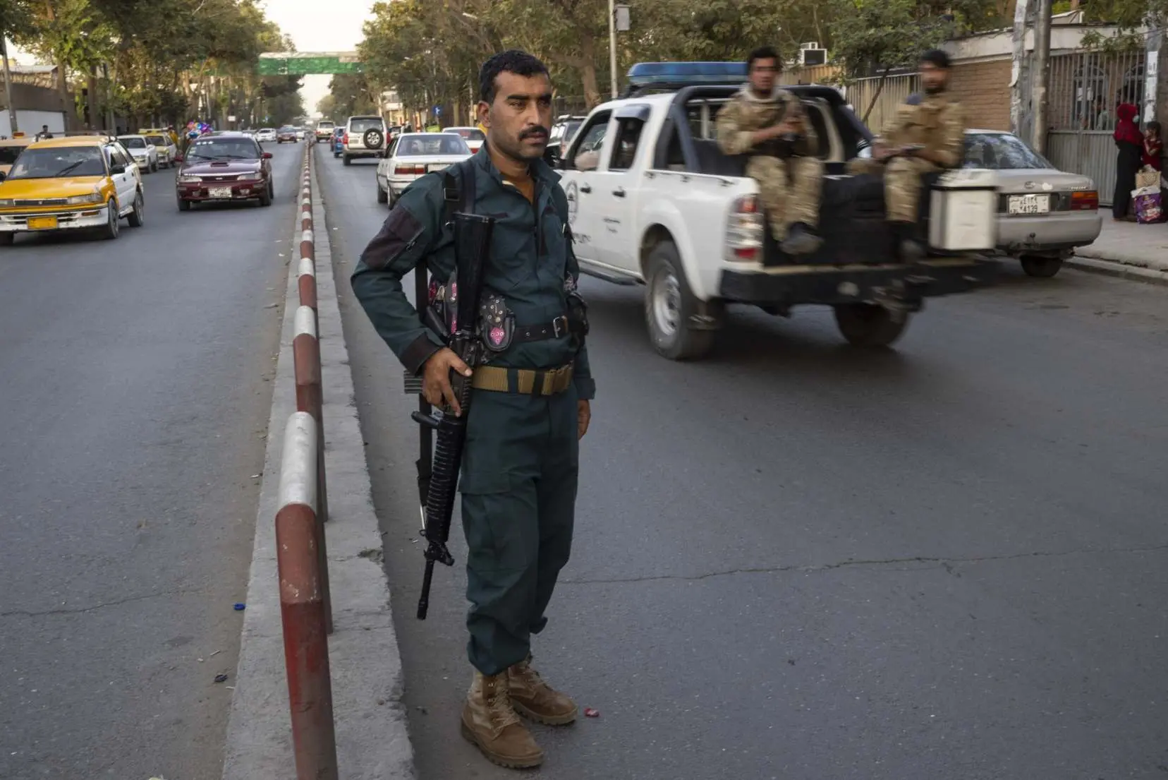 Kabul police stands in street.