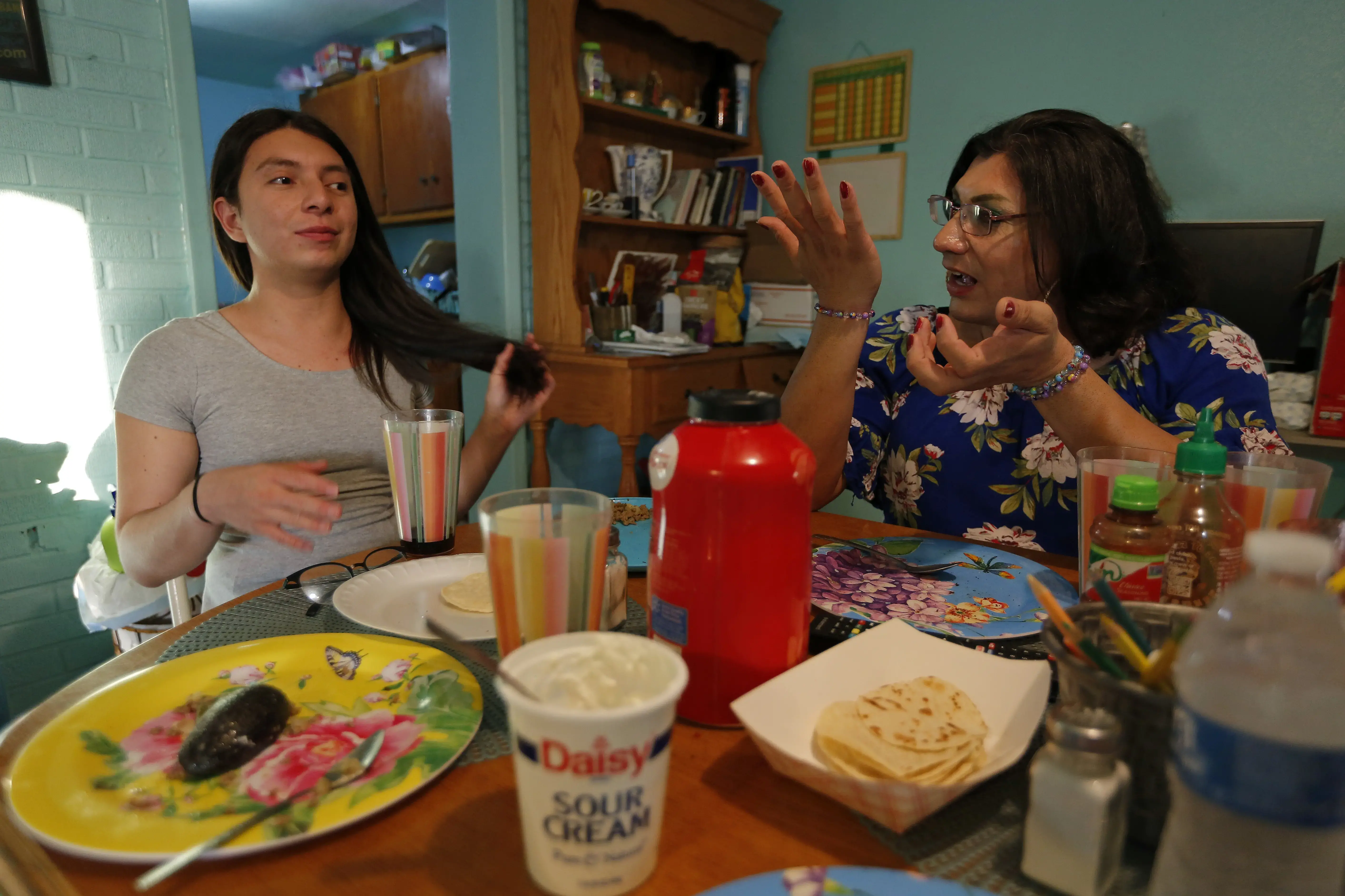 Two women talk over dinner