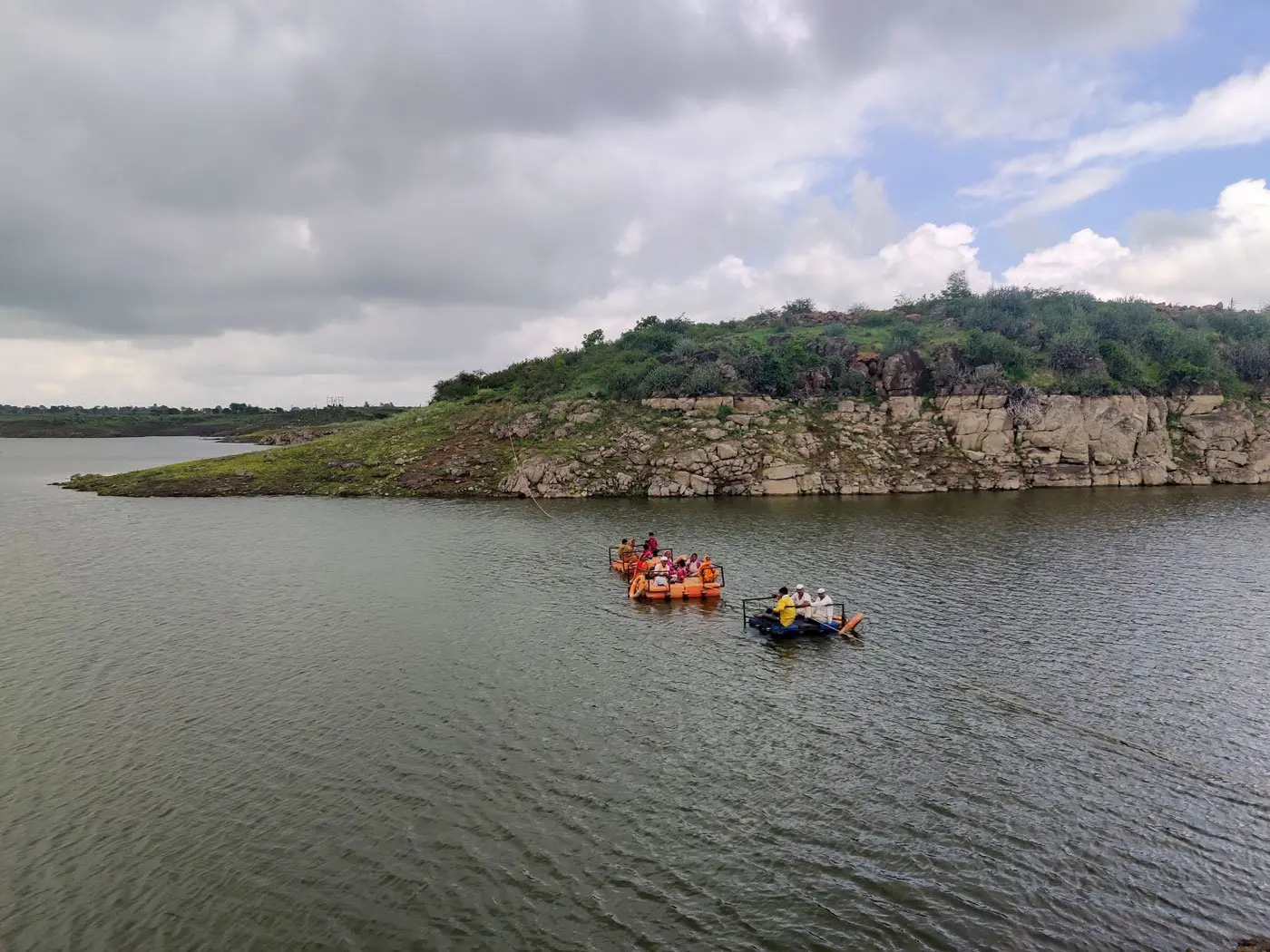 People crossing the river in boats