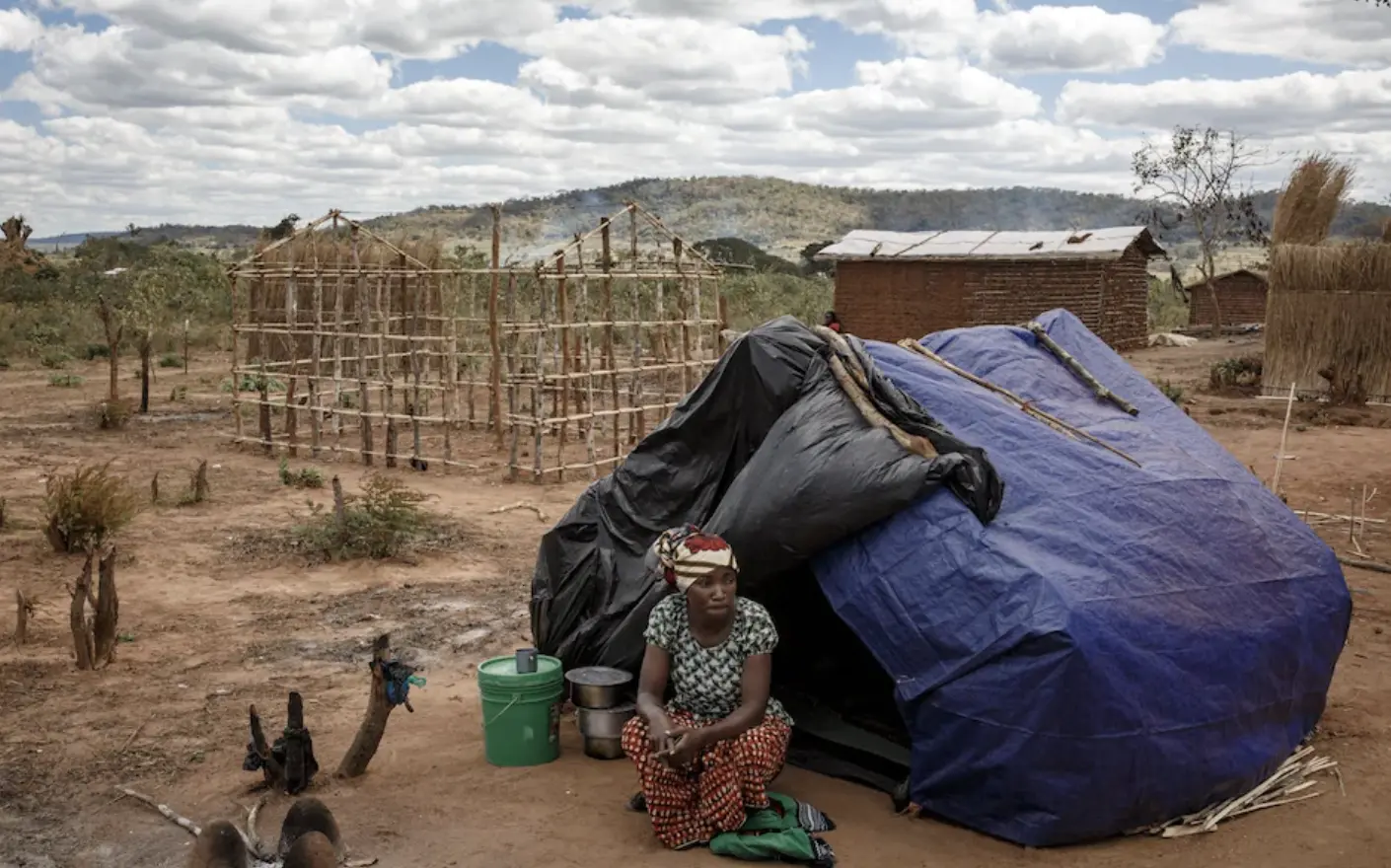 Woman sitting in front of tent.