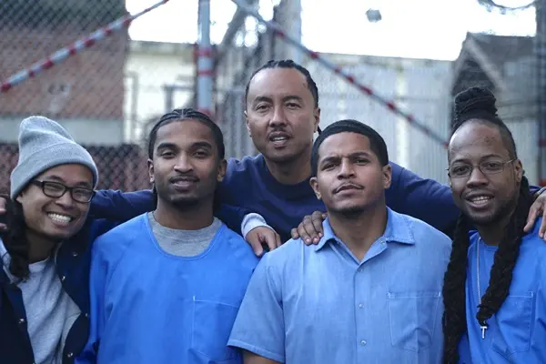 A group of five people pose for a photo.