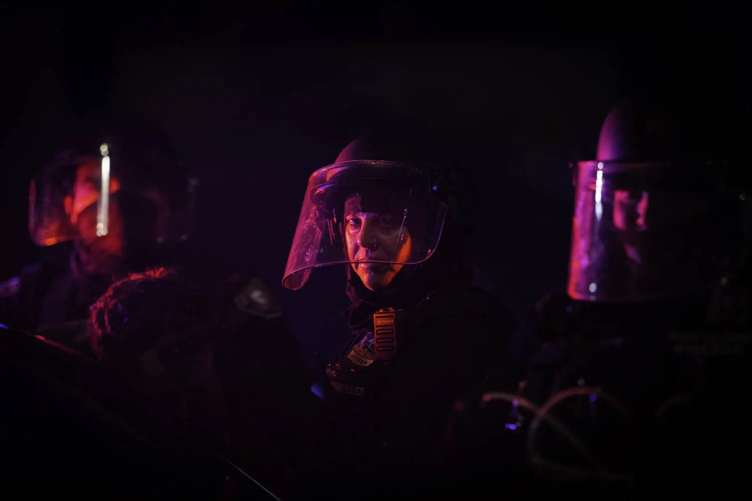 A Portland Police officer looks up while arresting a protester in Portland, Oregon.