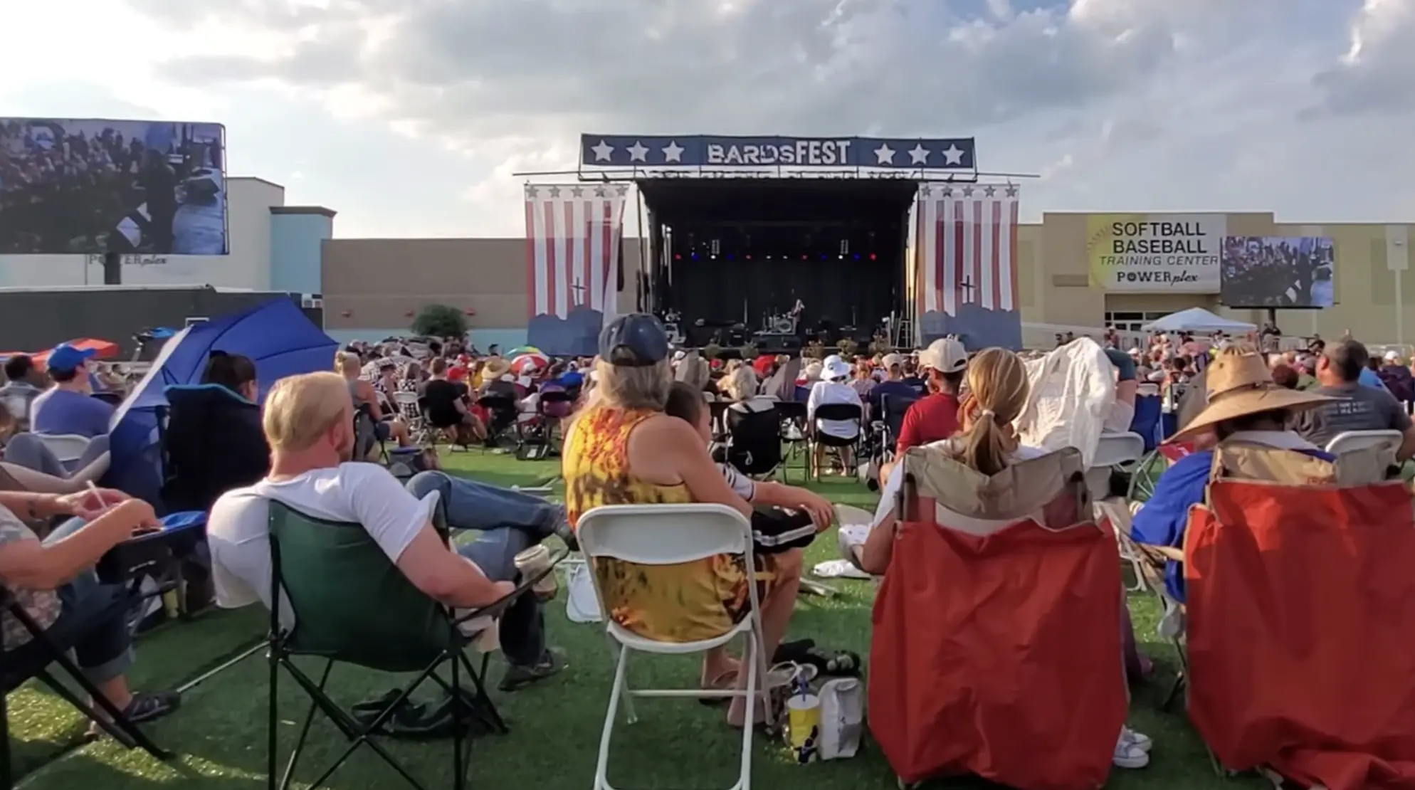 Crowd sits on folding chairs at Bard Fest