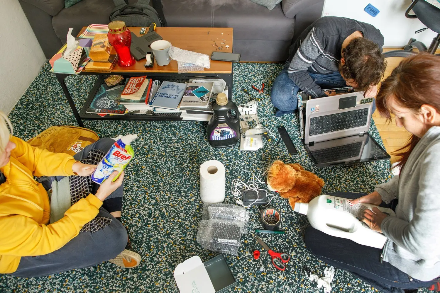 People laying on the floor with the waste items