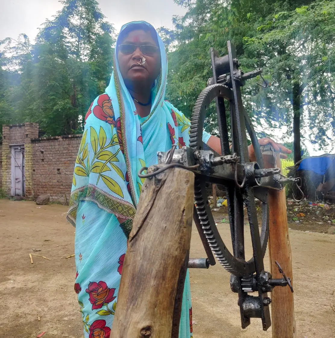 Woman stands outside her house