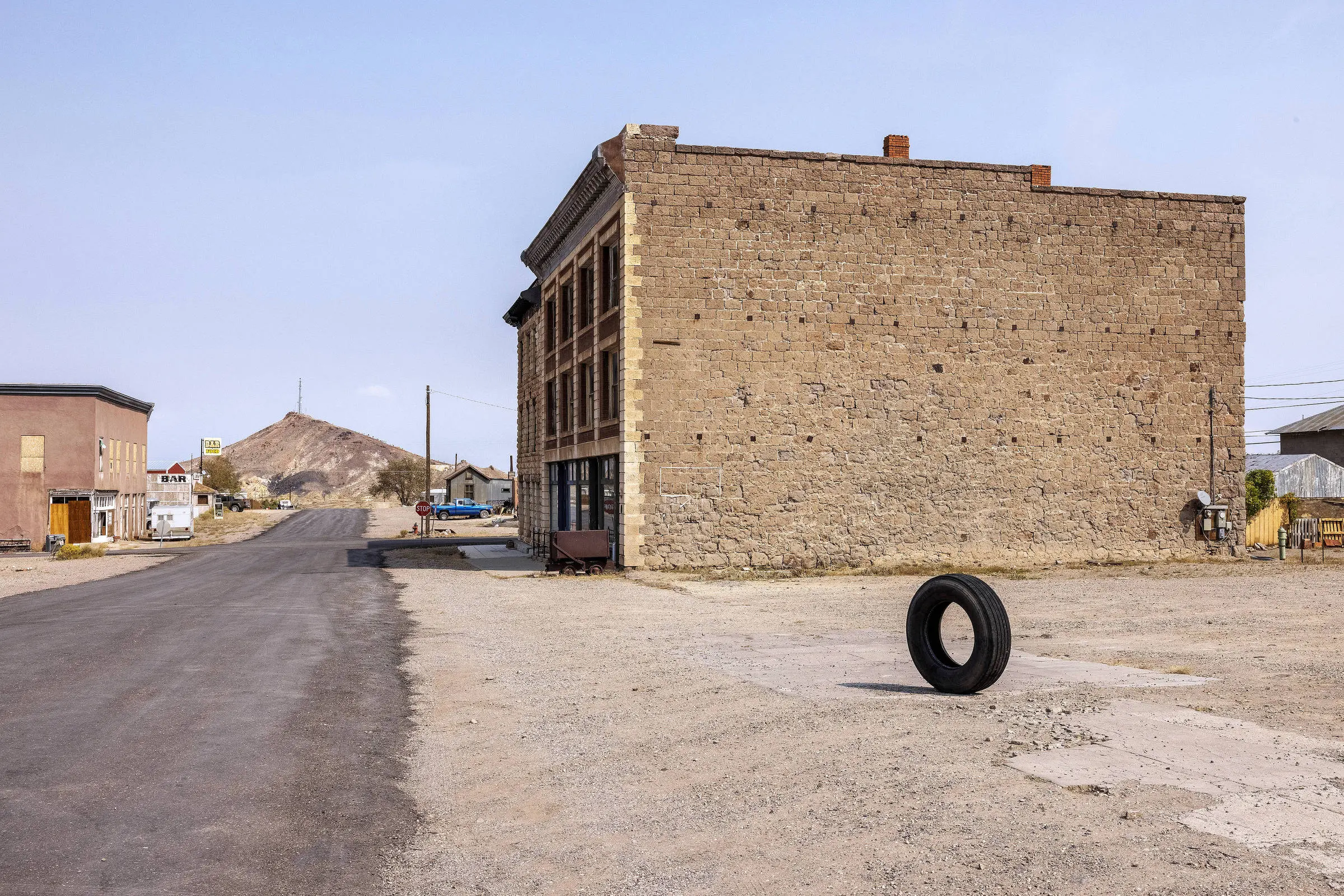 Photo of tire in front of old abandoned building