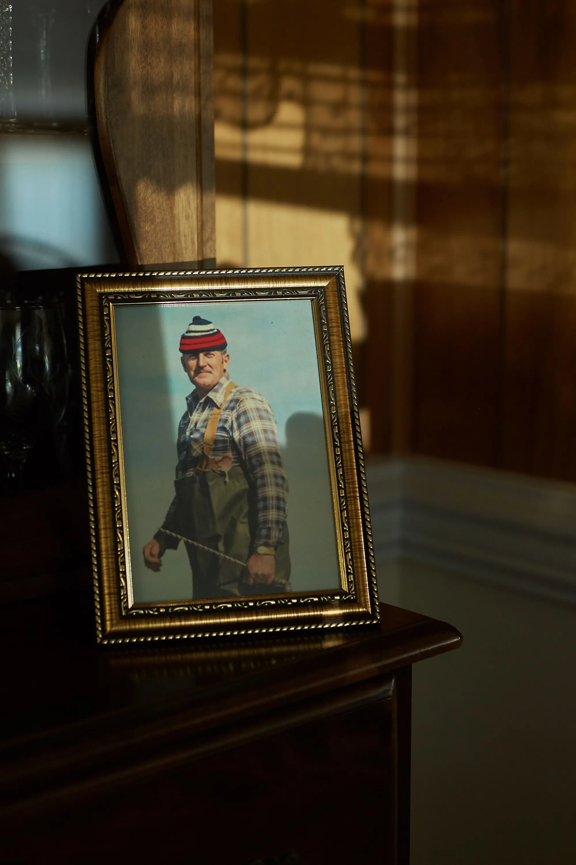 Photo of a man sits on a dresser