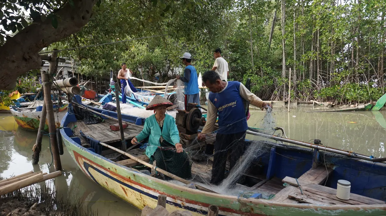 A woman sits in fishing boat