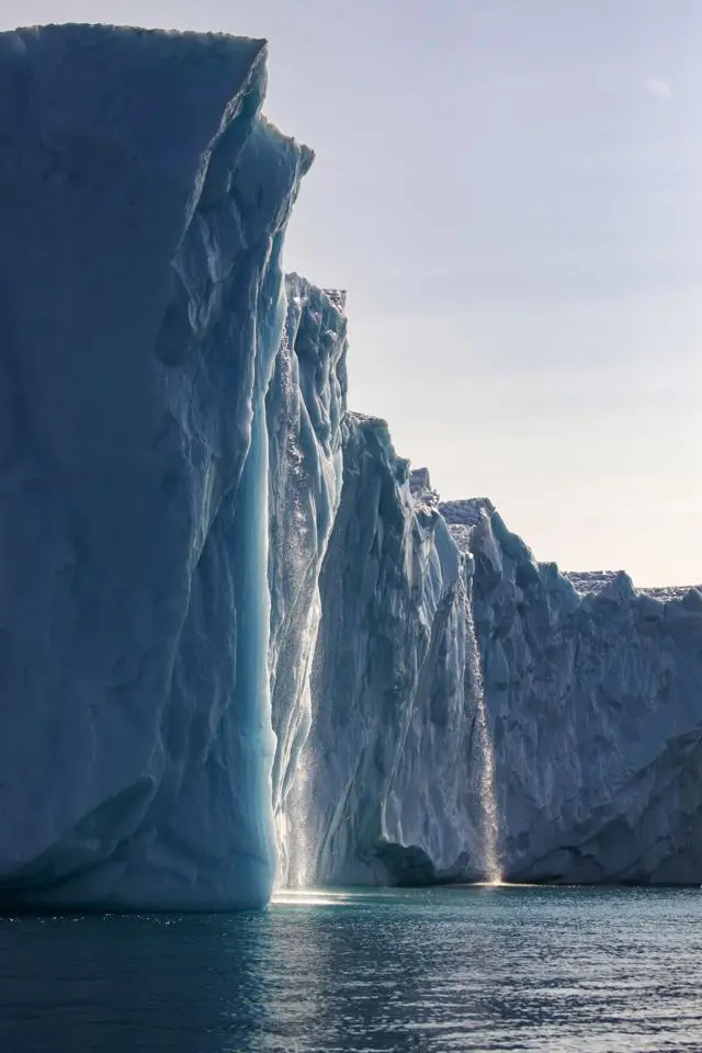 Meltwater pours off the side of glacier