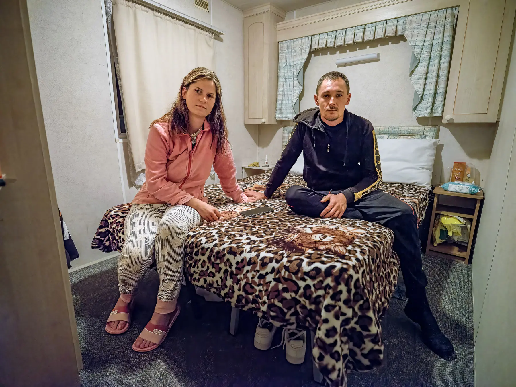 Couple sits on a bed