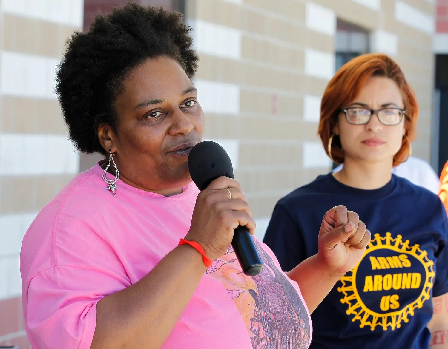 Woman speaks into a microphone