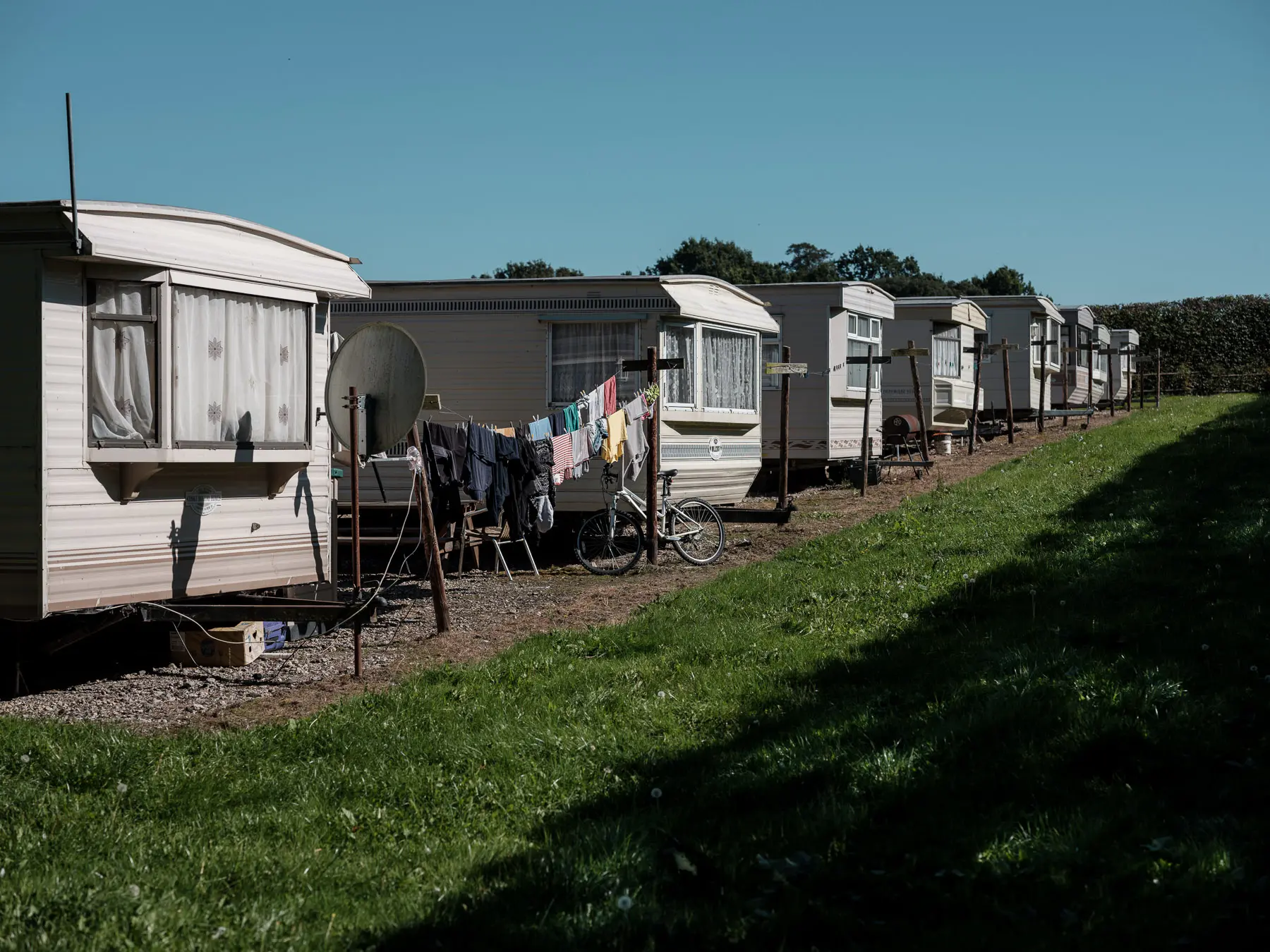The caravans lined up in a row with laundry hanging out to dry