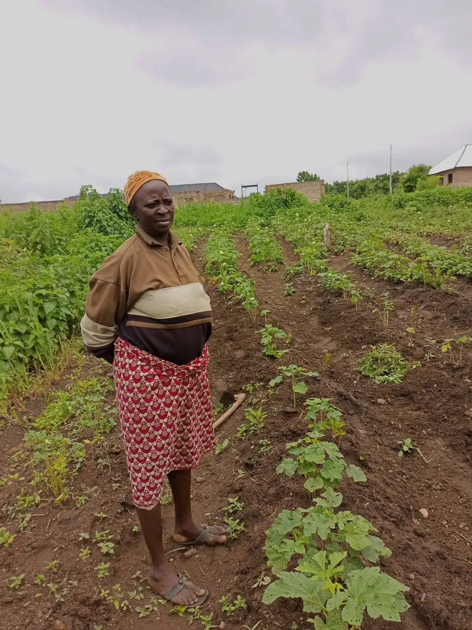 Woman stands in front of farmland