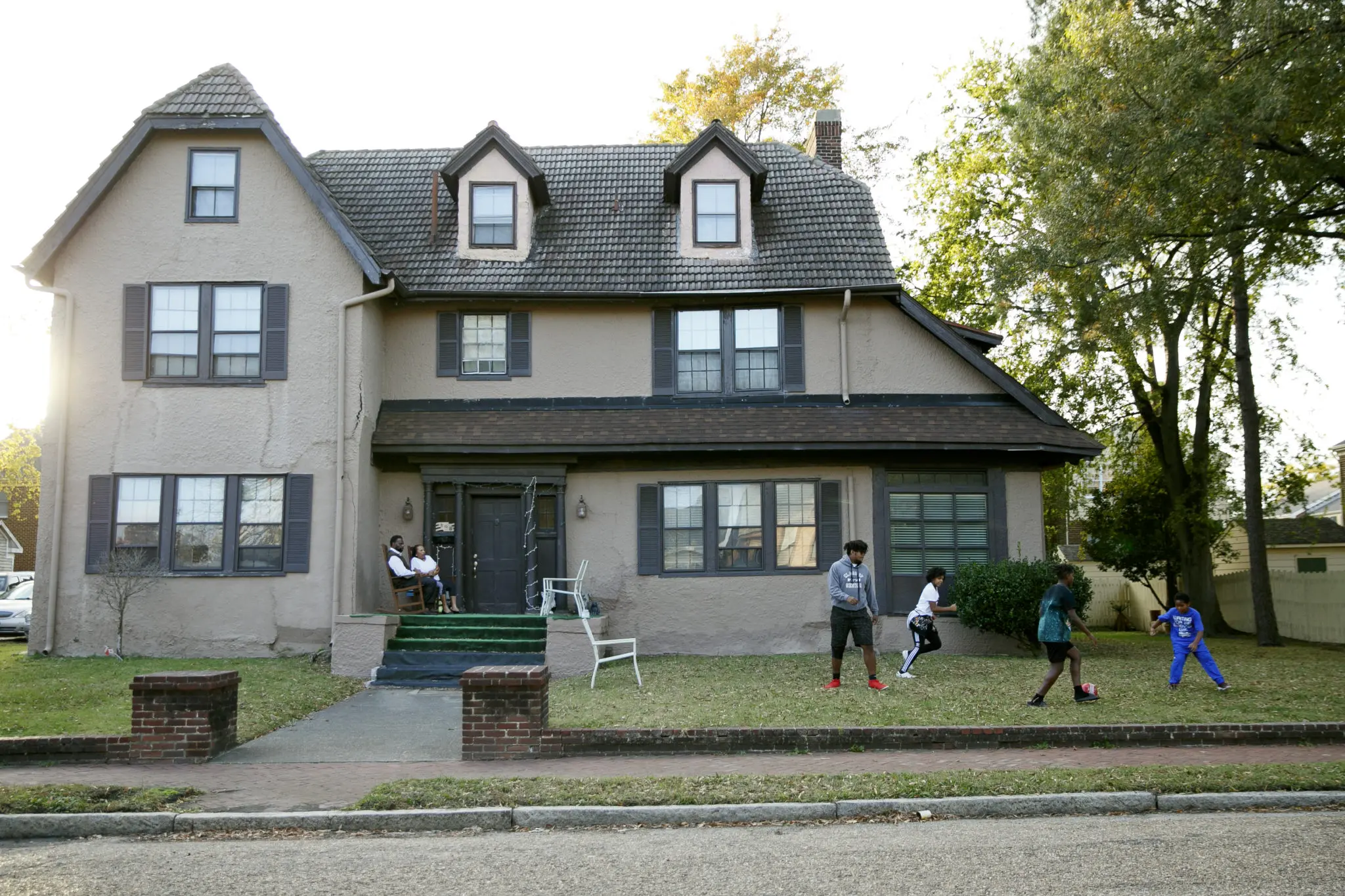 Margaret and Bobby Buxton watch their grandchildren play soccer in front of their Portsmouth home