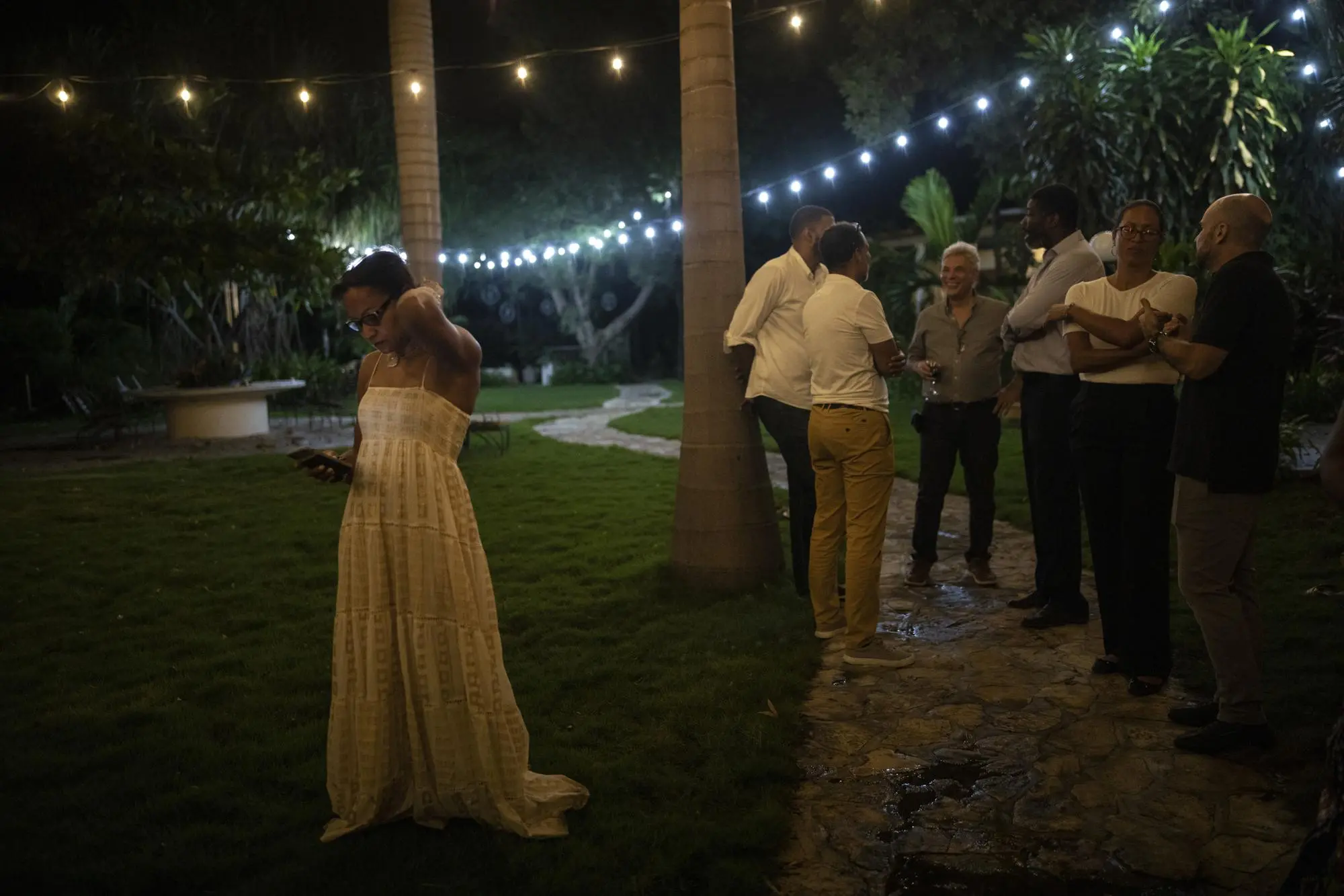 A business woman checks phone at cocktail party