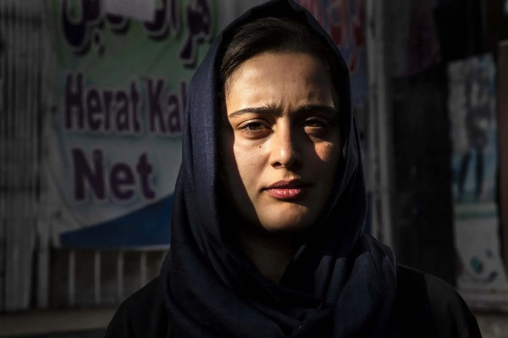 Portrait of a woman in Afghanistan standing outside cafe