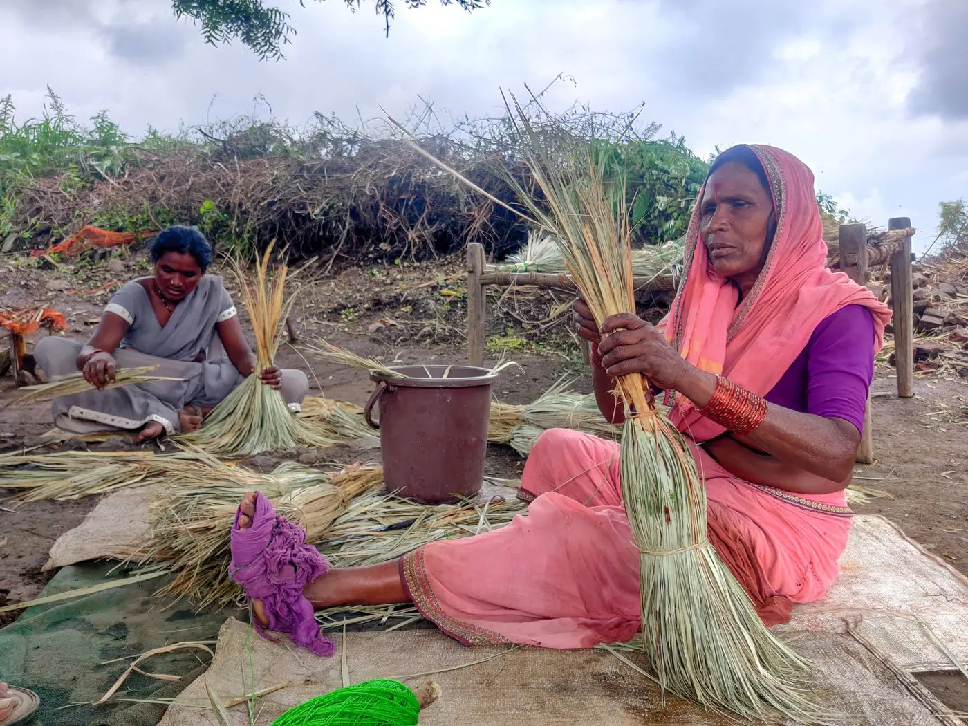 Woman binds brooms despite her weak eyesight.