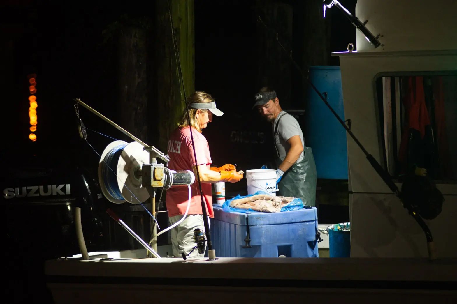 Peeling fish in boat