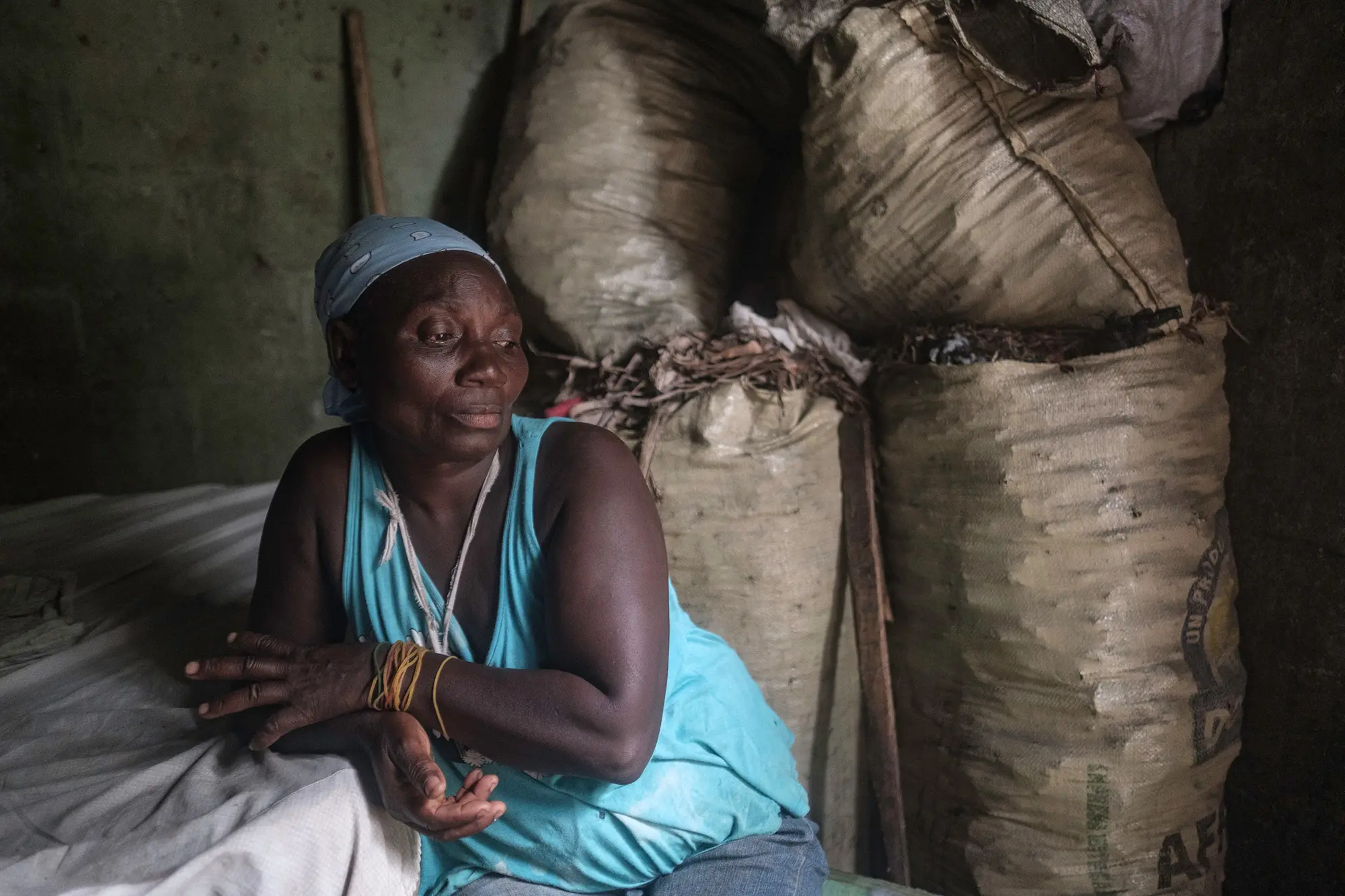 A woman sits on pile of coals