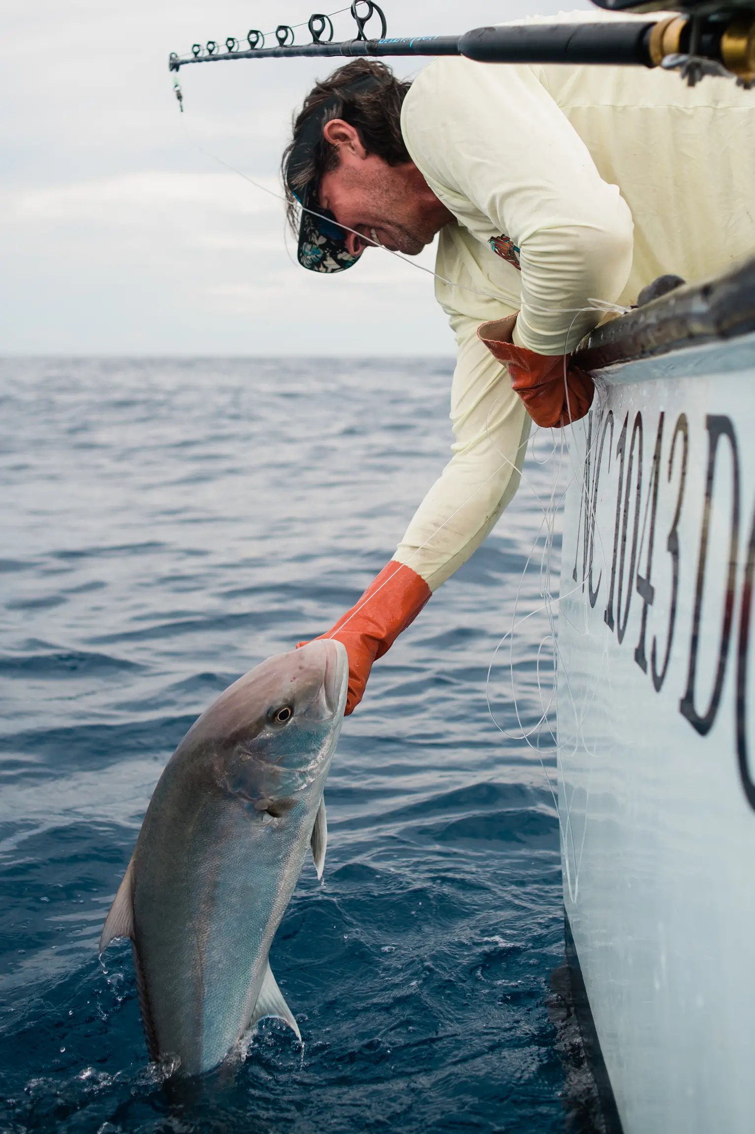 A man pulling fish out of boat