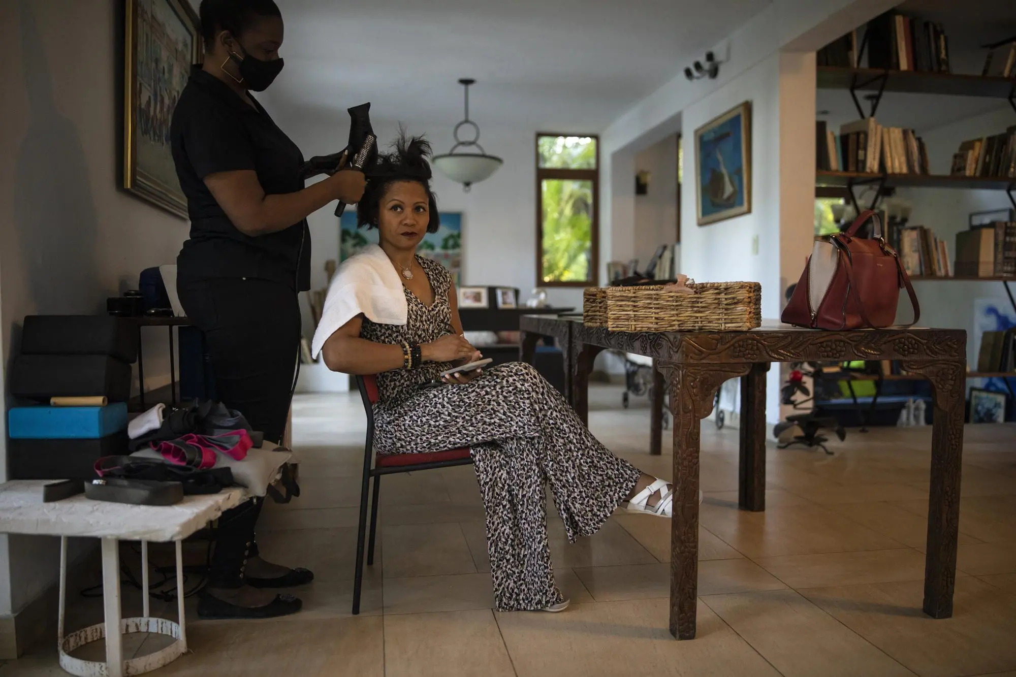 A businesswoman gets hair done