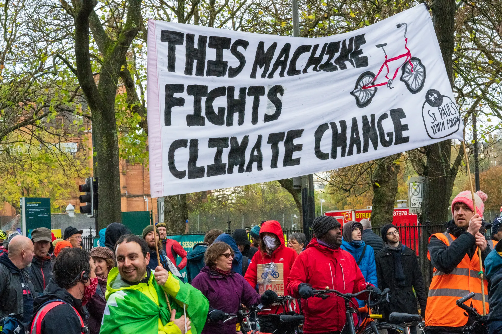 sign reads "This Machine Fights Climate Change"
