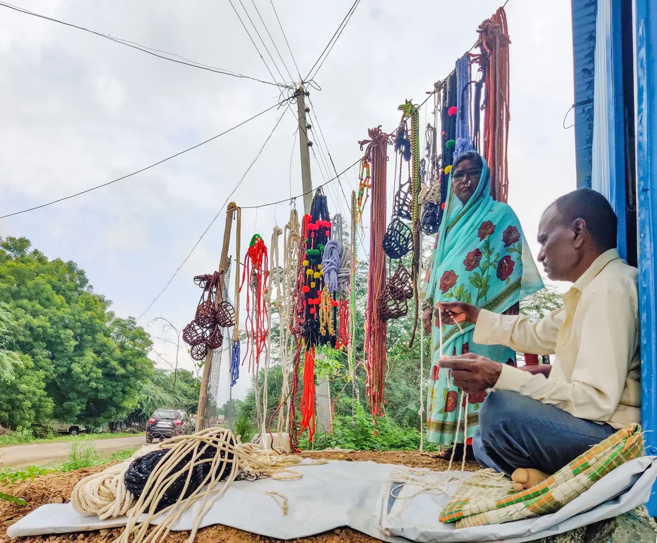 Couple selling ropes on side of the road