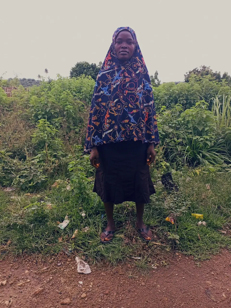 Woman stands in front of farmland