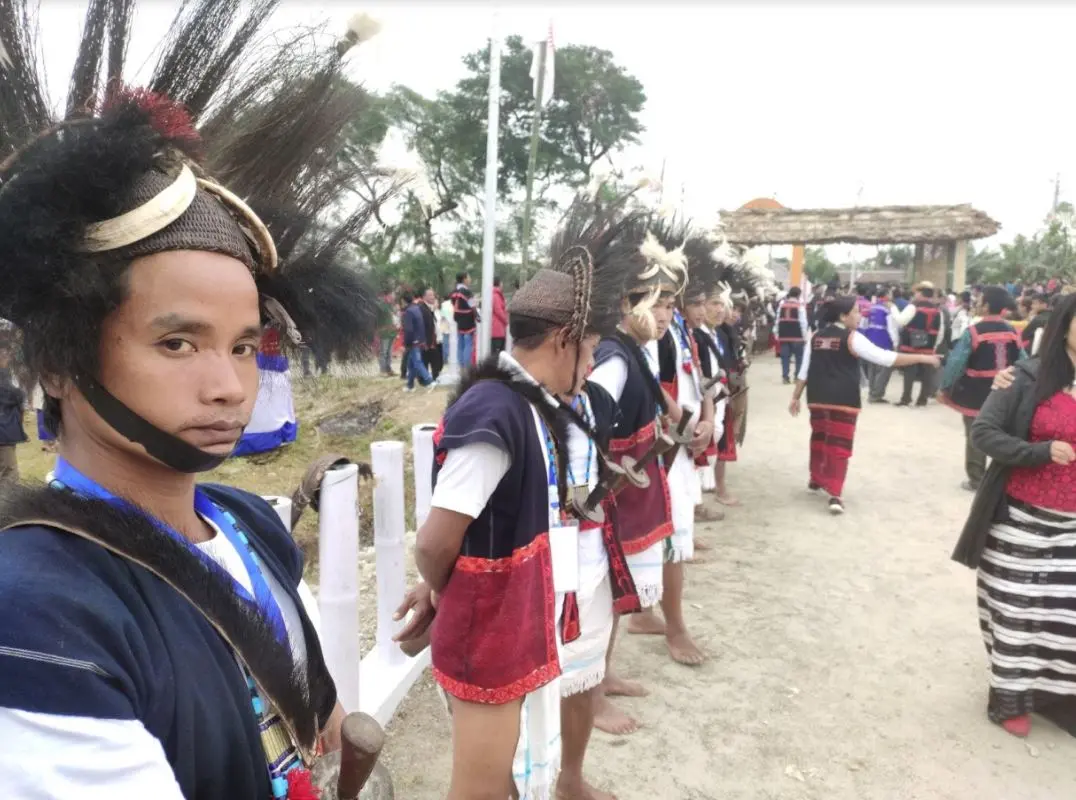 People in traditional dress at a ceremony.