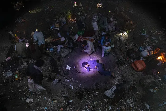 man lays on ground in crowded area