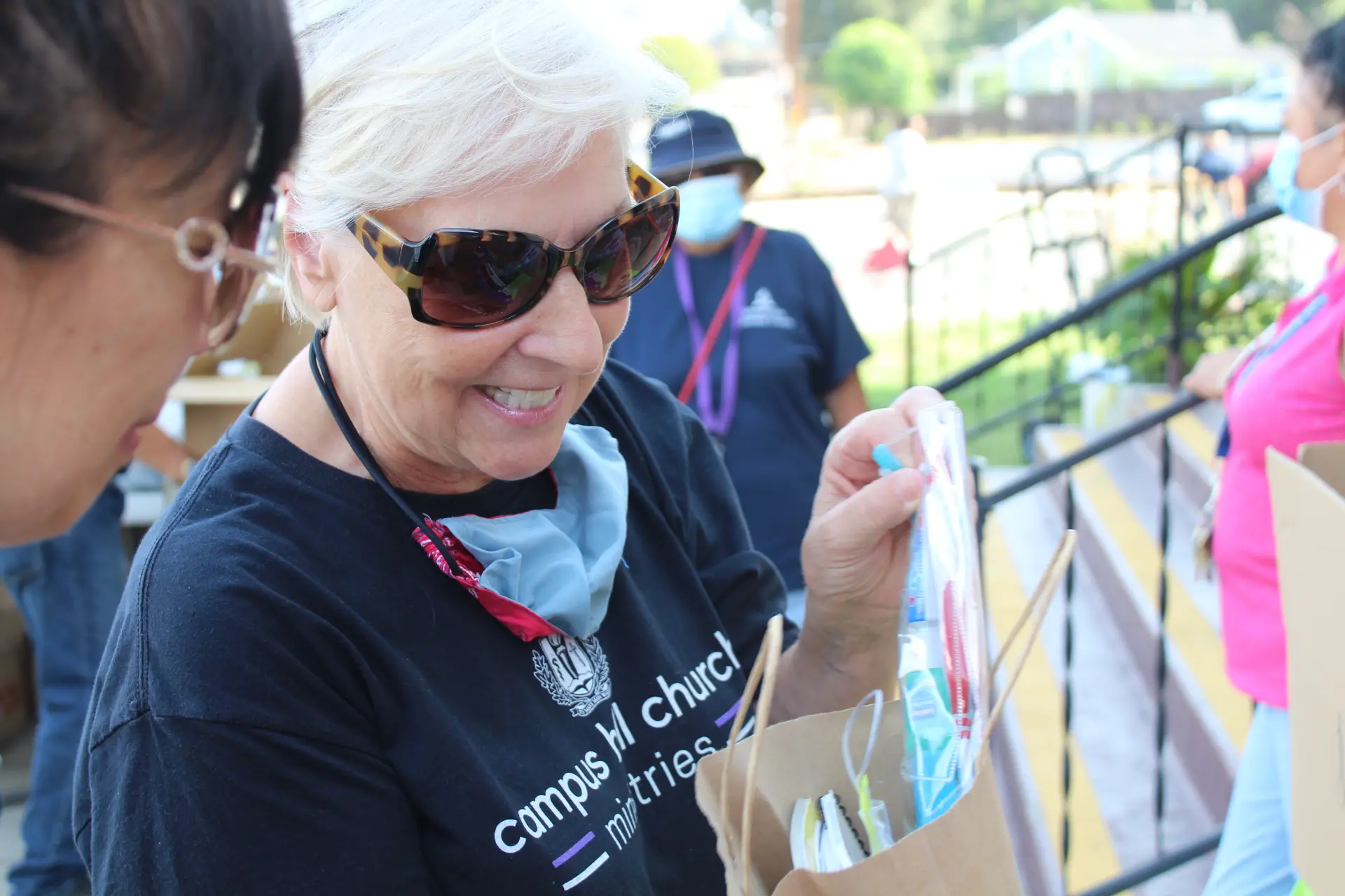 a woman smiles at a bag 