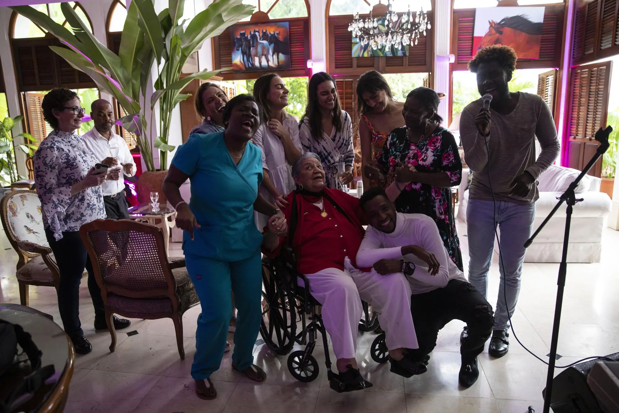 A group gathers for a photo celebrating a birthday