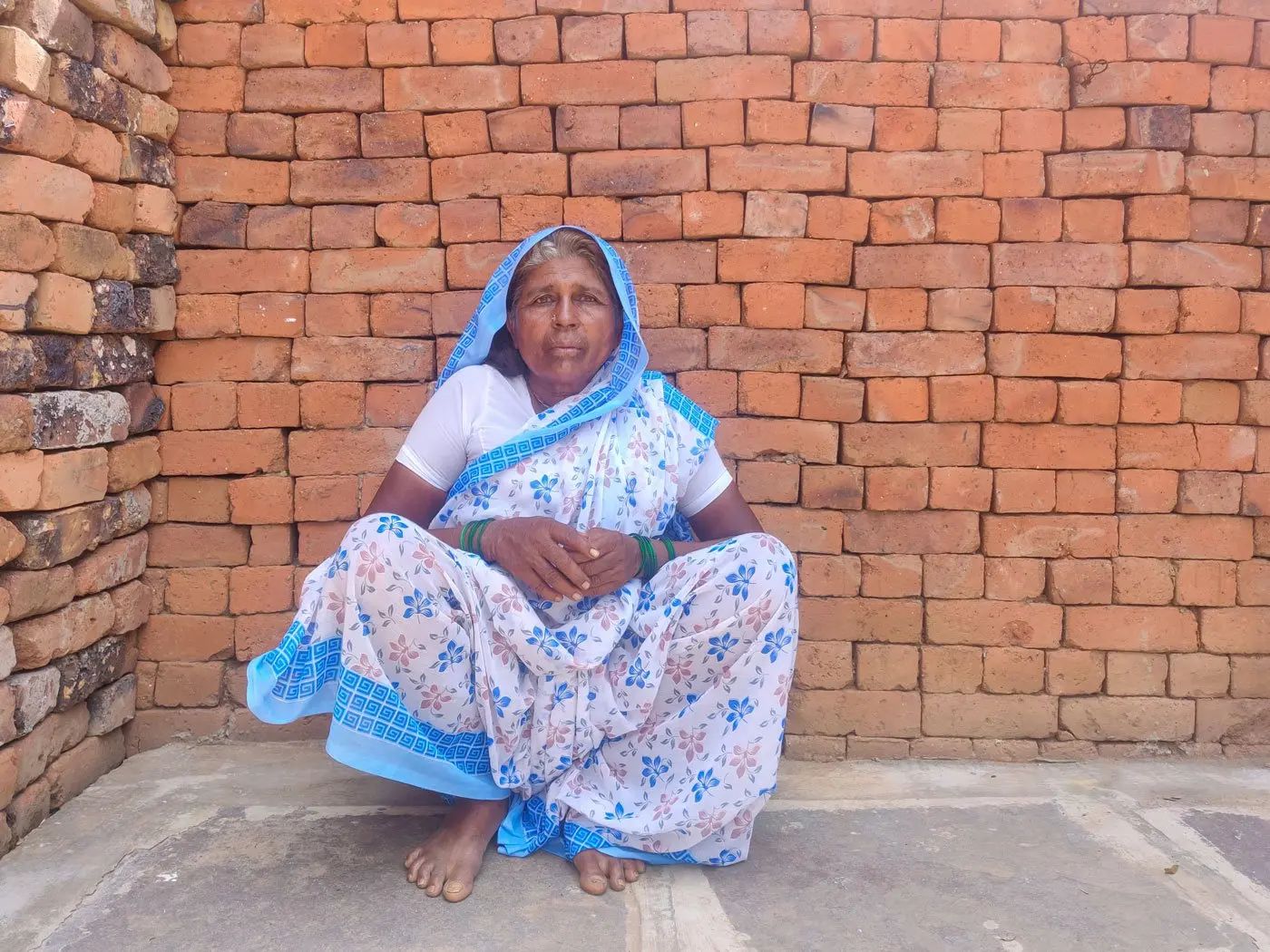 Woman sits on ground