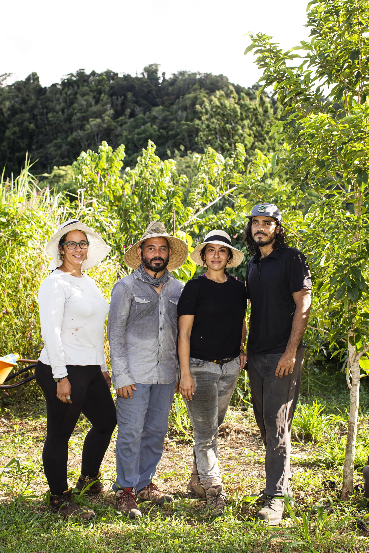 Family poses for photo after a day of farm work