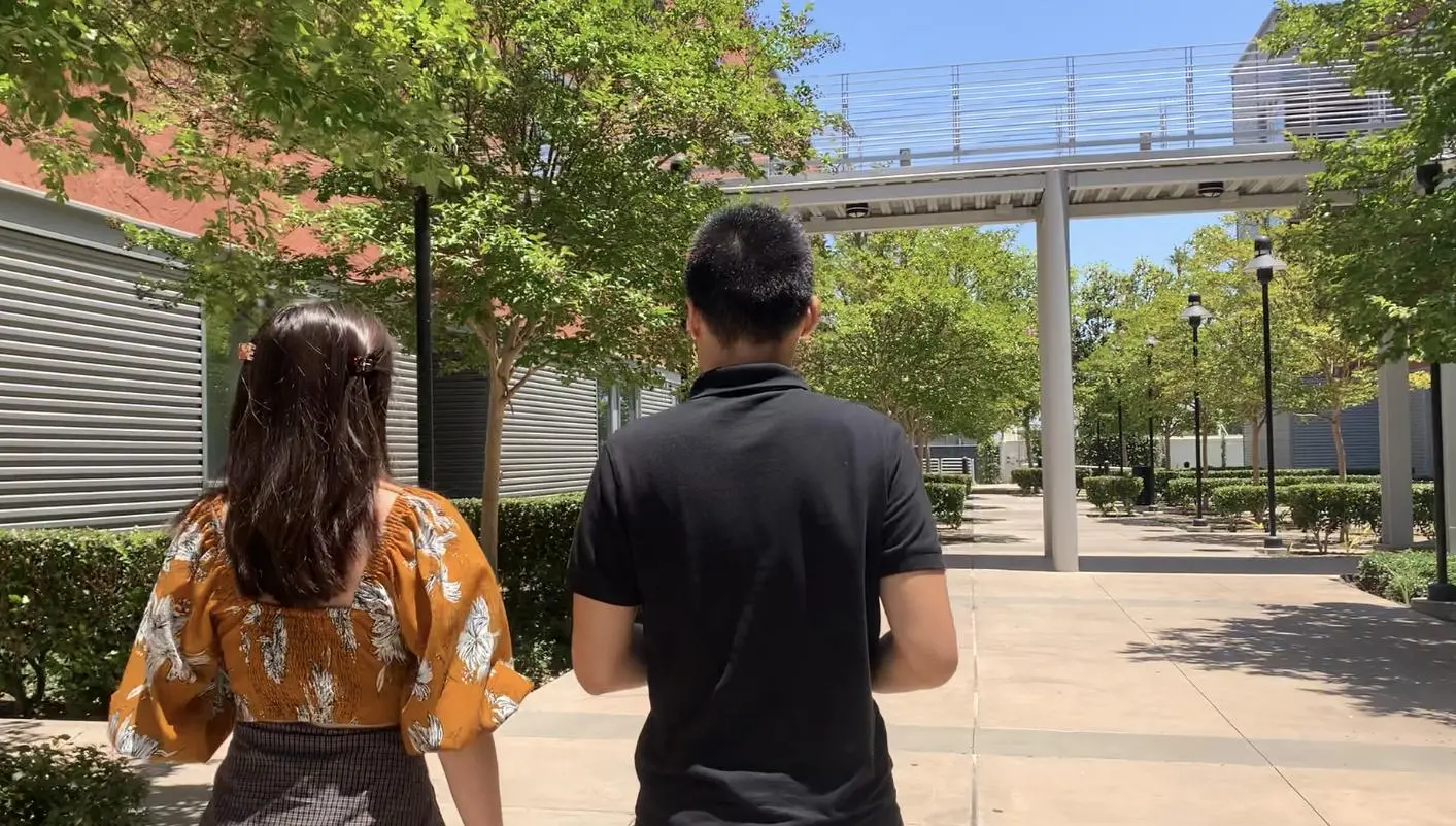 Nina Reyes (left) and Michael De Guzman (right) walk to the undergraduate lab at Cal State LA