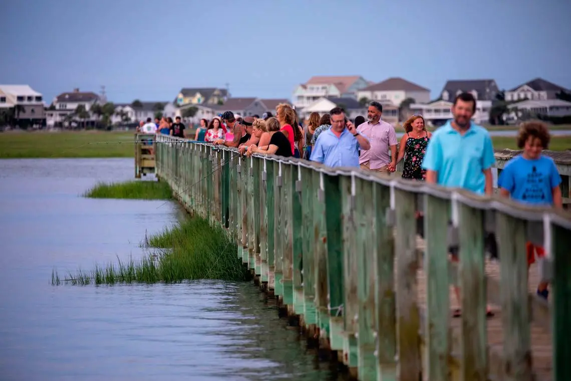 Visitors look out on the pier in South Carolina