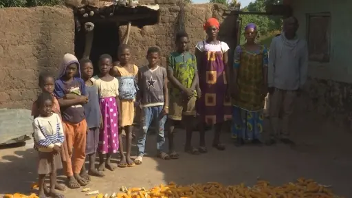 Family stands next to one another for a photo