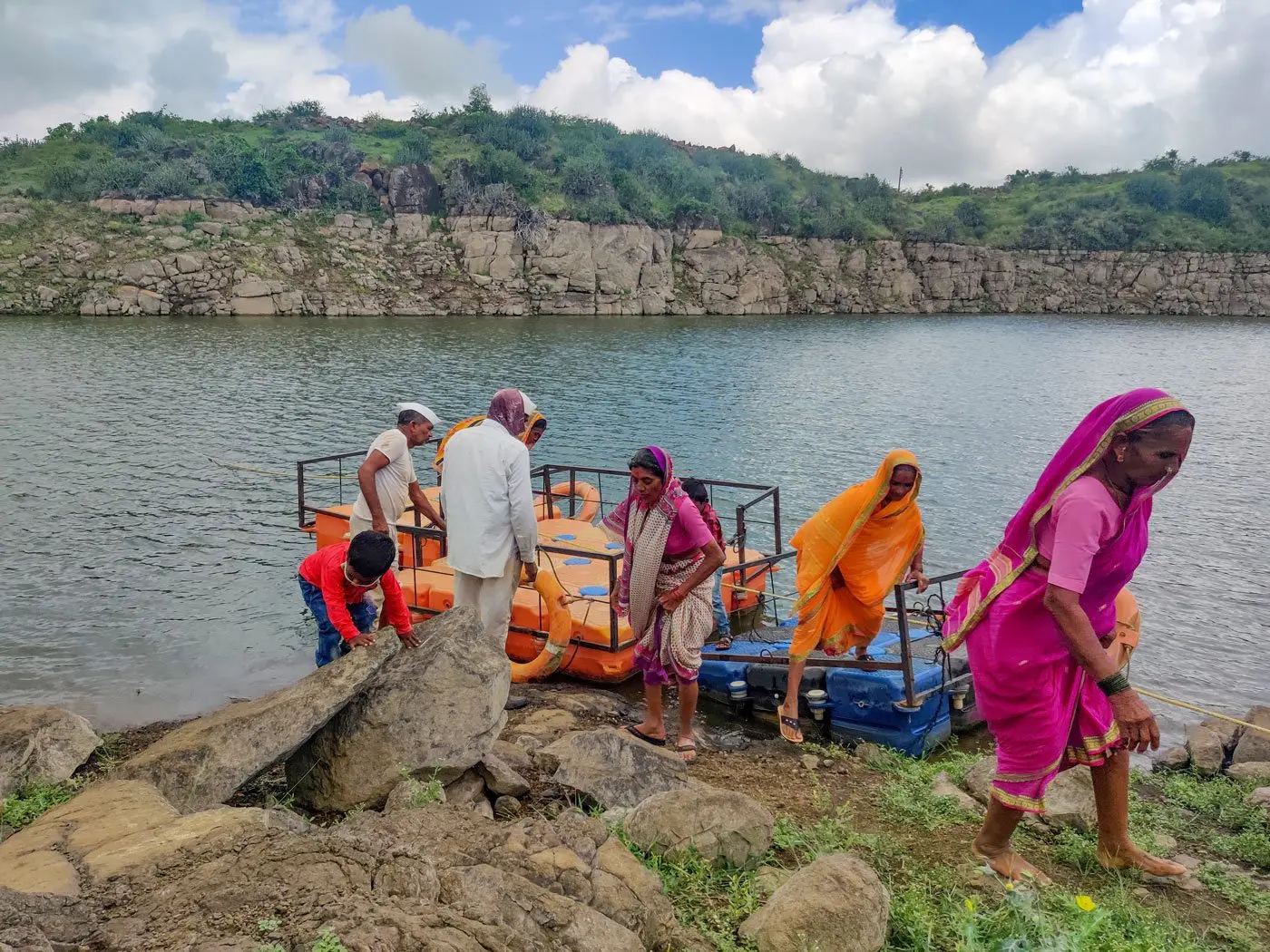 Members of village climbing out of rafts