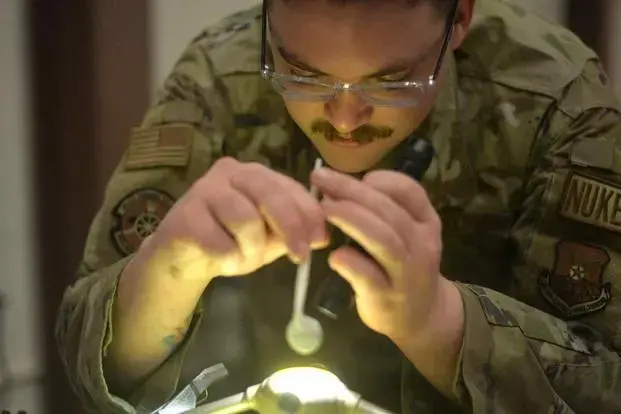 Staff Sgt. Daniel Ulibarri, a maintainer at F.E. Warren Air Force Base, works on a component on Jan. 17, 2024. (Jacob Byk/Military.com)