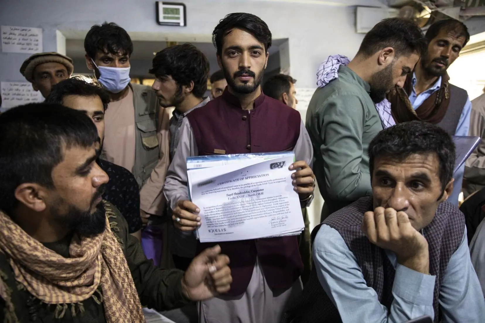 A man holds special visa application materials in office