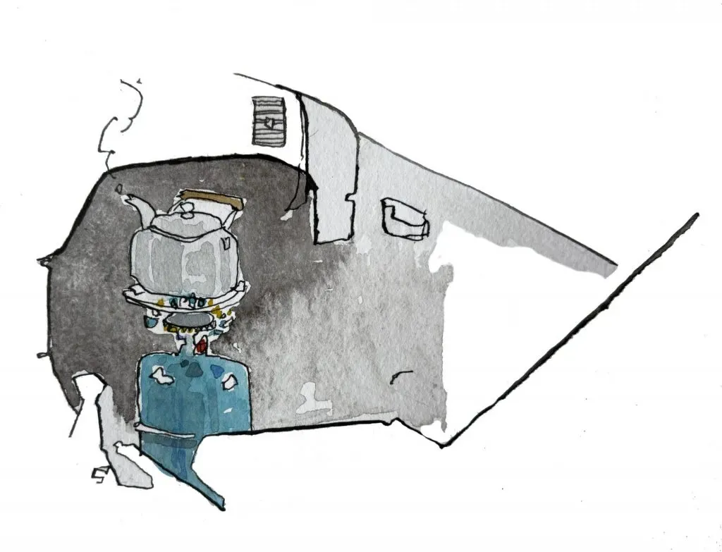 Below the interior of a car door and dash, a blue natural gas cylinder is rigged to a metal kettle, whose steam is rising from the spout.