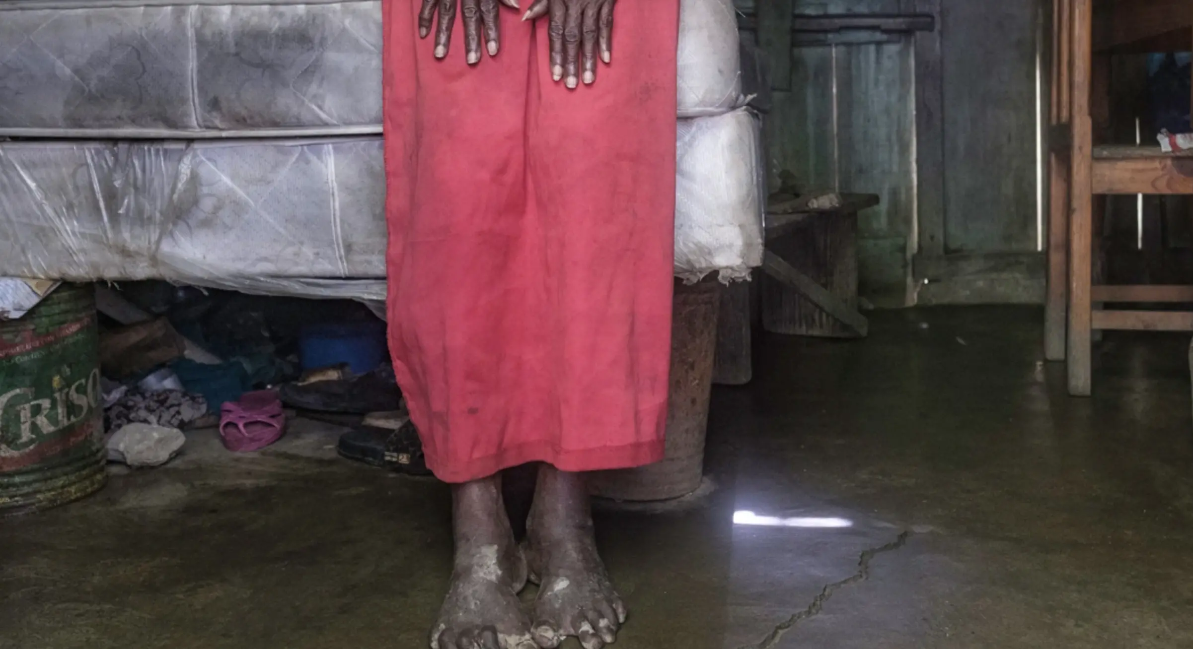 A woman stands in her home