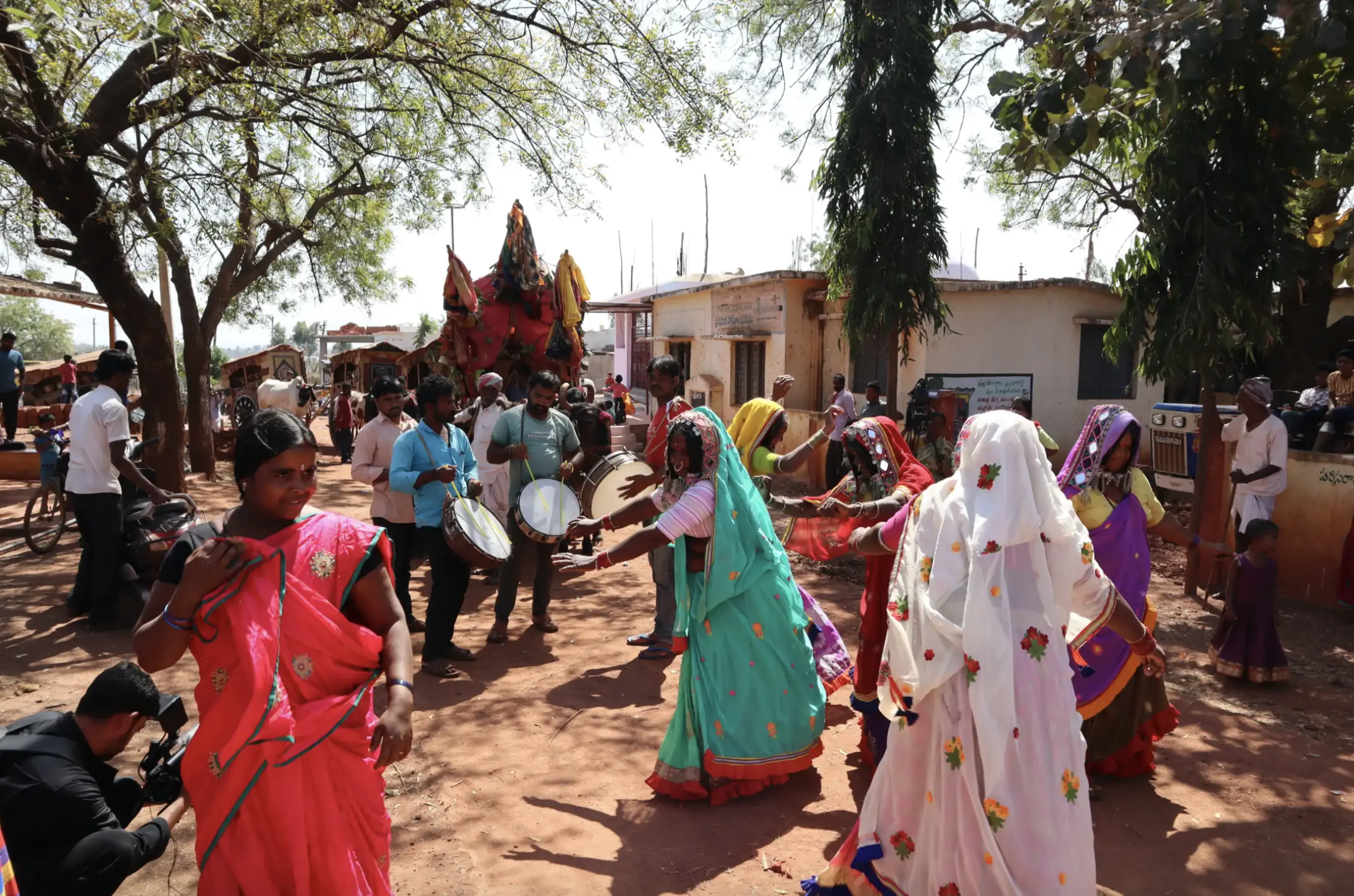 People dance and play music at a festival.