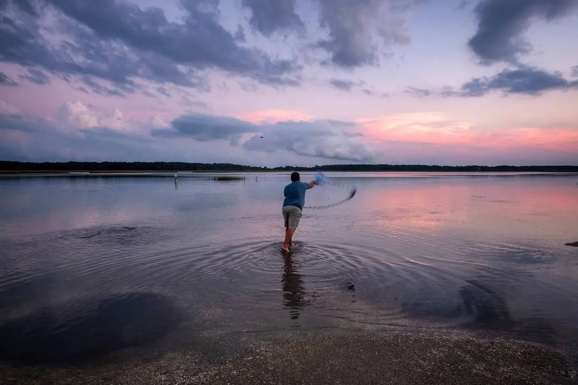 Man throwing water in inlet