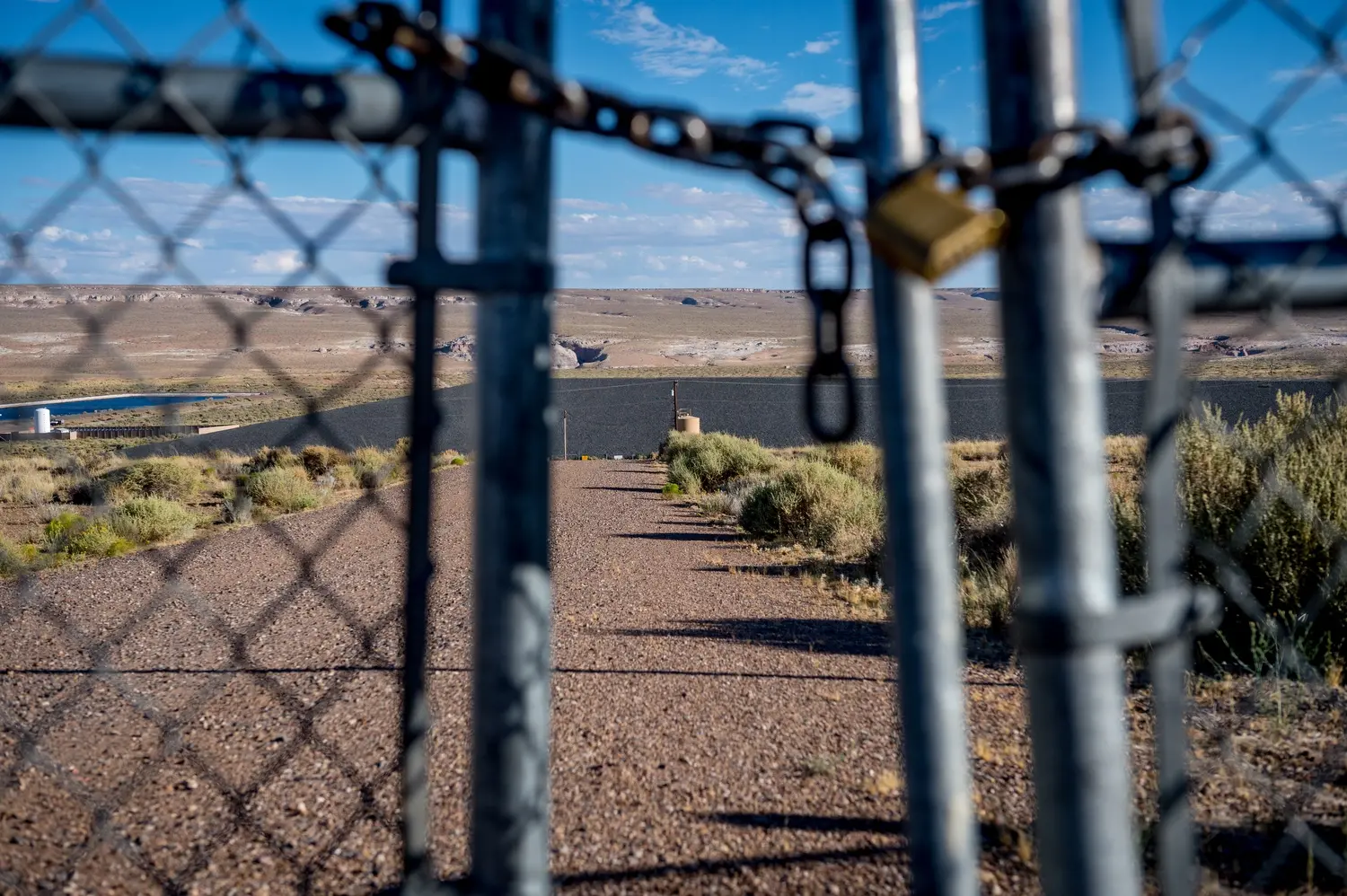 The fence surrounding the capped uranium mill site operated by the Rare Metals Corporation outside Tuba City. Image by Mary F. Calvert. United States, 2020.