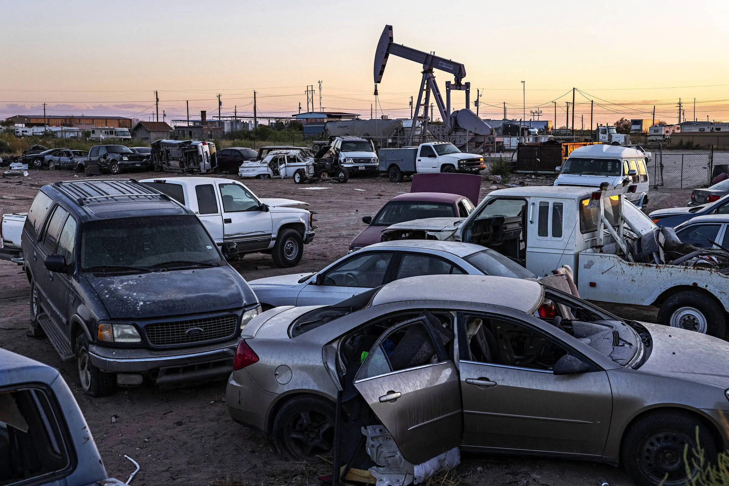 Oil well next to a junkyard near the city of Odessa