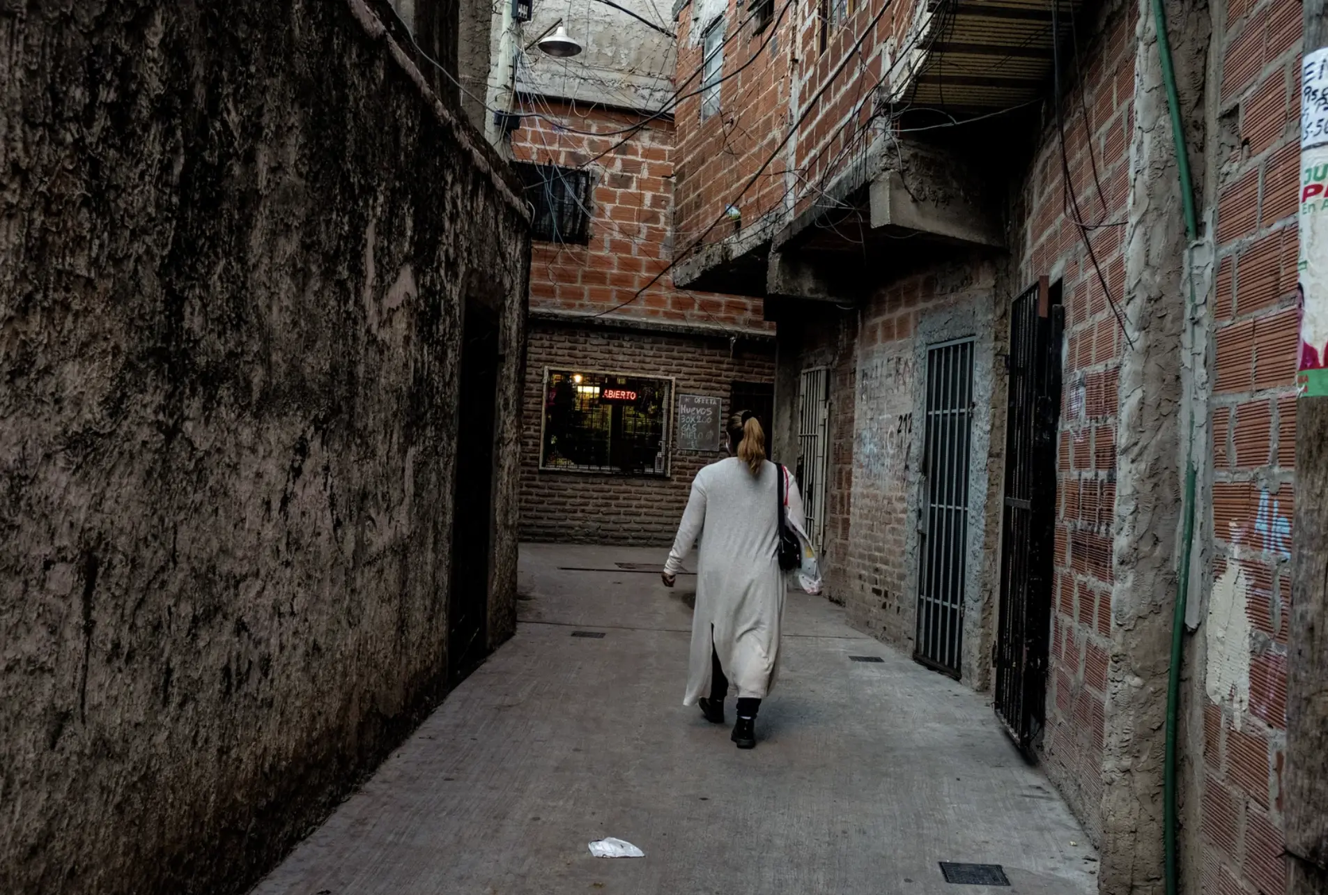 a woman walks down ally